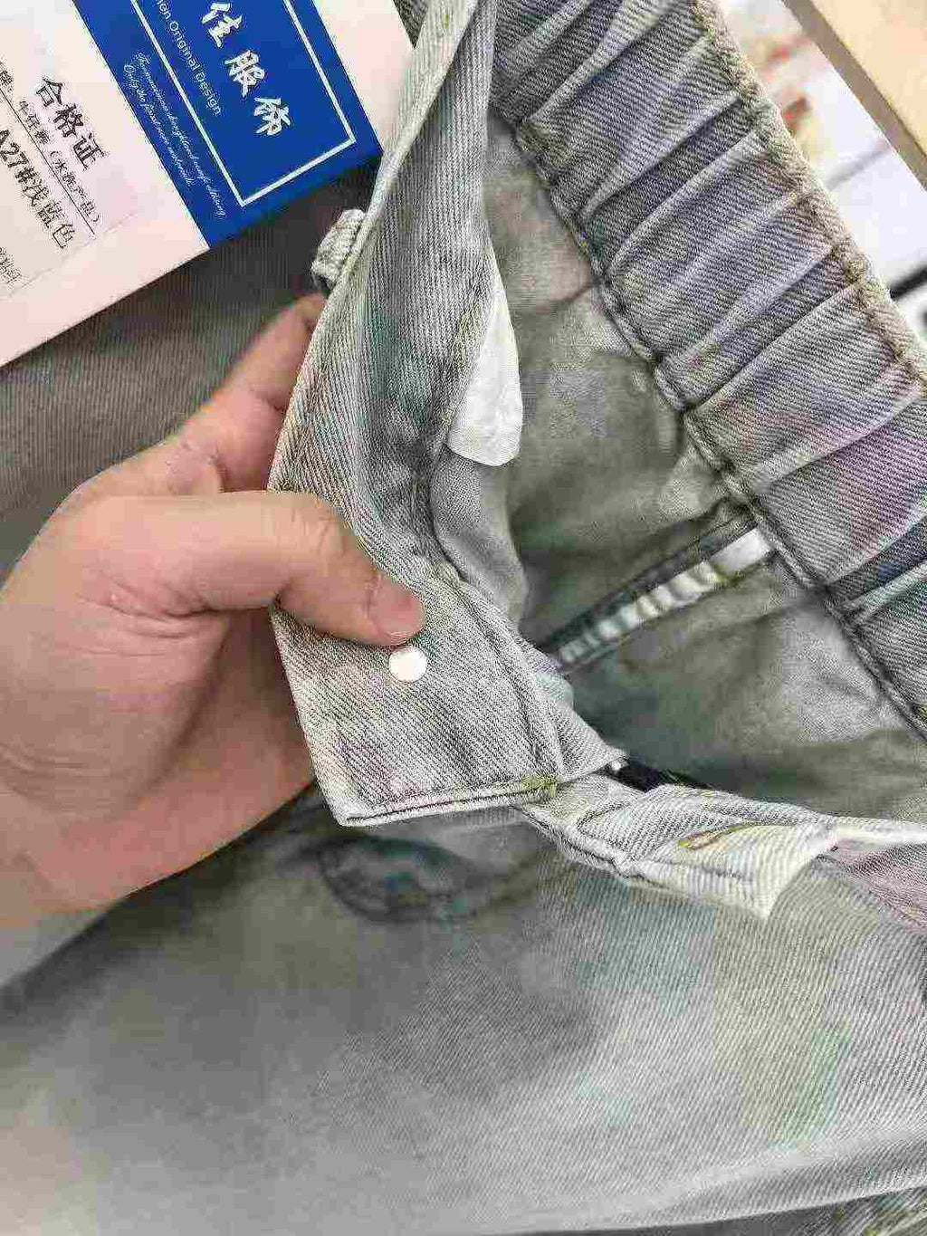 Women's washed stretch waistband jeans with a hole in the bottom